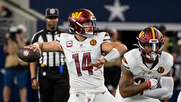 Washington Commanders quarterback Sam Howell (14) passes against the Dallas Cowboys during the first quarter at AT&T Stadium.